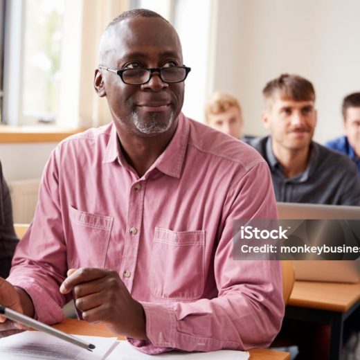 Mature Student Using Digital Tablet In Adult Education Class